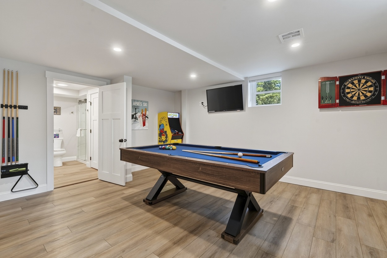 Basement game room with pool table, darts and Pac-Man arcade