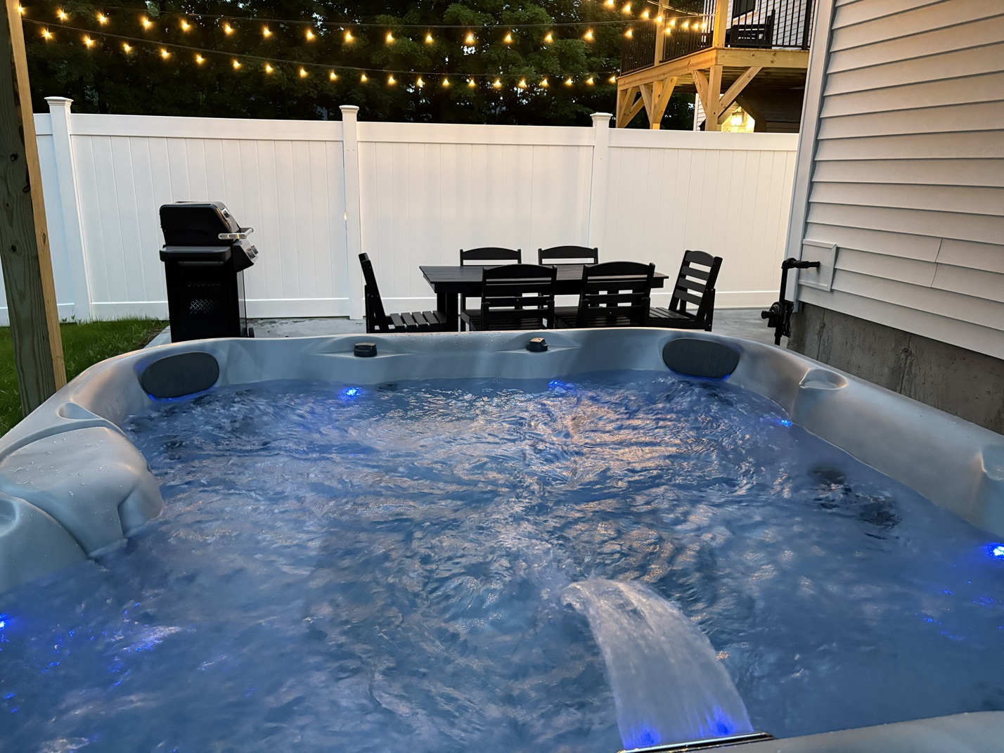 Carriage House 7-person hot tub and grill in its private fenced yard